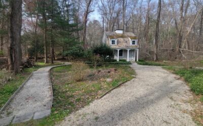 Here we removed a large stump and a few bushes and added a gravel base with 1 1/2″ river stone.